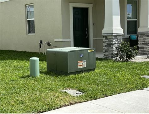 green electrical transformer box|green box outside house.